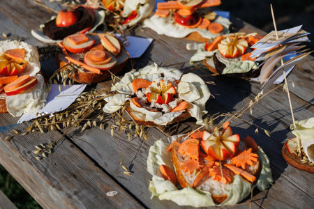 A stunning and vibrant array of artistic vegetable decorations artfully arranged on a lovely wooden tableの写真素材
