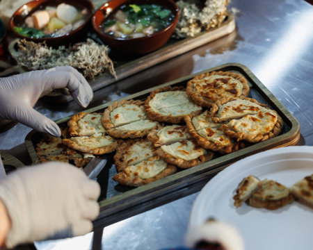 Fluffy pancakes, skillfully made, pair beautifully with rich soup and fresh greens served on the sideの写真素材