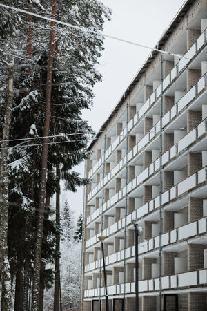 SnowDusted Pines Frame BalconyLined Facade Evoking Roadside Stopover During Winter Road Trip Empty