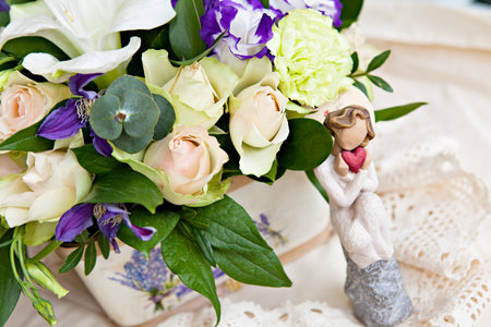 White and lilac bouquet with an angel with heart の写真素材