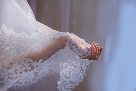 Lace veil in the hand of the brideの写真素材