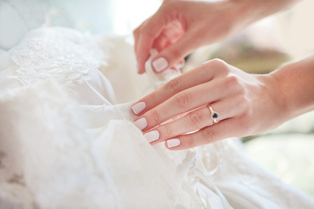 Buttoning wedding dress, arms with buttonsの写真素材