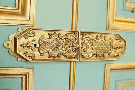 trim on the doors, the handle decorated with monograms and gold