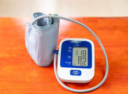 Sphygmomanometer show blood pressure and heart rate memory on wooden table.の写真素材