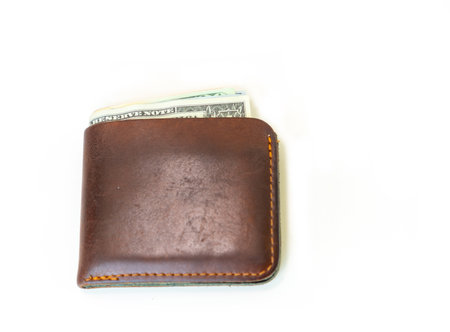 Brown leather wallet with dollars bills isolate on white background.の写真素材