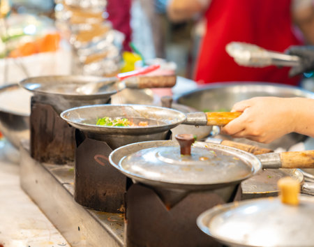 Baked shrimp with glass noodles in casserole at street food market.の写真素材