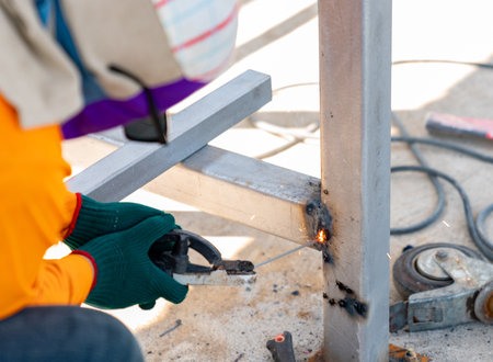 Close-up of the welder's hands welding metalの写真素材