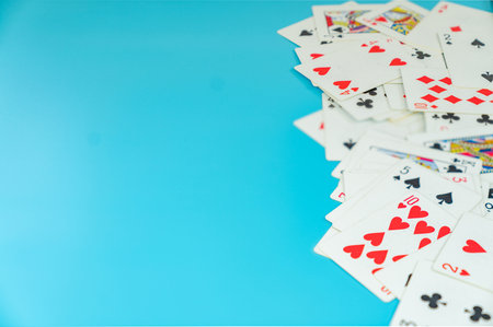 Many playing cards on aqua background, copy space text.の写真素材