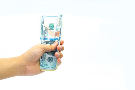 Man hand holding Dollars banknote isolate on whtie background.の写真素材