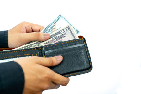 Close up dollar bill in the wallet, Male hands get it out. Making purchases, paying for things, american currency conceptの写真素材