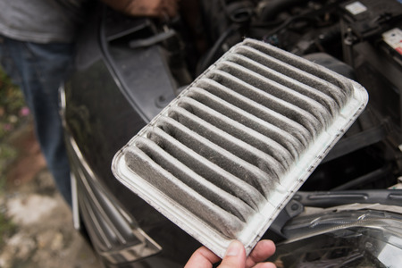 Close up of  old car air filter in hand