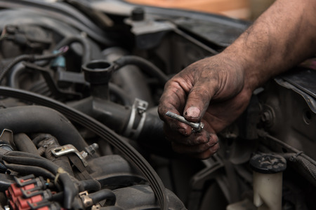 Close up of engine part in mechanic handの写真素材