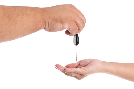 Close up of hand wait the key on white background isolatedの写真素材