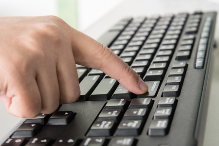 Close up finger pressing backspace on keyboardの写真素材