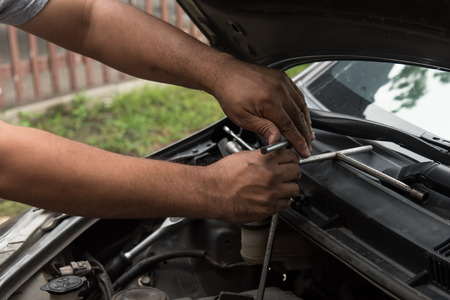 Close up of mechanic hand fix the engineの写真素材