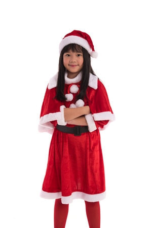 Close up of cute asian girl dress up in santa claus suite on white background isolatedの写真素材