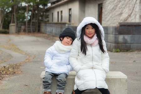 Close up of cute asian sister and brother travel kaga onsen japan in winterの写真素材