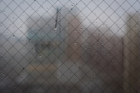 Close up of wet glass with blurr city backgroundの写真素材