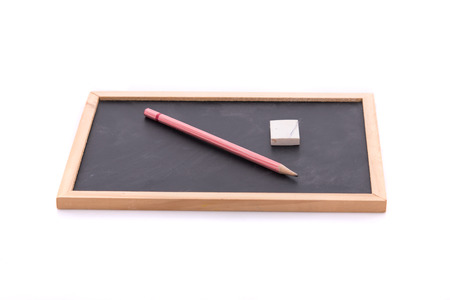 Wooden blackboard and pencil on white background isolated.の写真素材