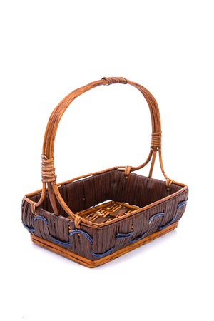 Close up of empty wooden gift basket on white background isolated.の写真素材