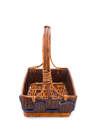 Close up of empty wooden gift basket on white background isolated.の写真素材