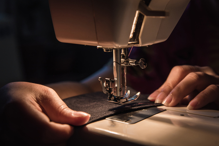Close up of sewing machine on the table in the night.の写真素材