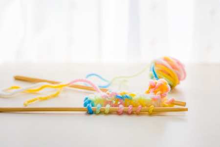 Close up of beautiful color yarn on the wooden table.の写真素材