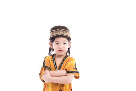 Close up of cute muslim boy on white background isolated.の写真素材