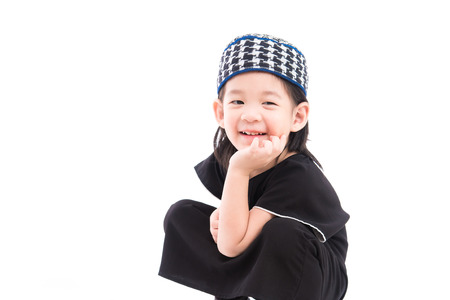 Close up of cute muslim boy on white background isolated.の写真素材