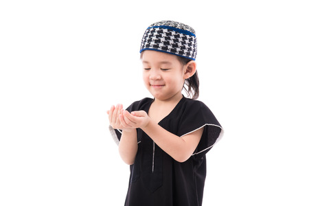 Close up of cute muslim boy on white background isolated.の写真素材