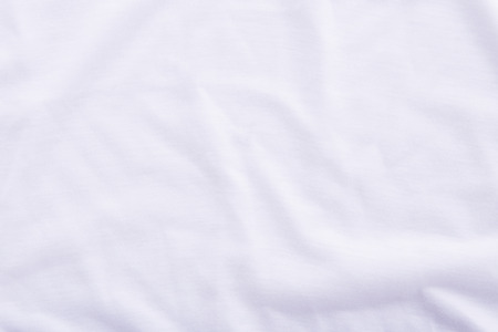 Close up of wrinkled white bedsheet texture background.の写真素材