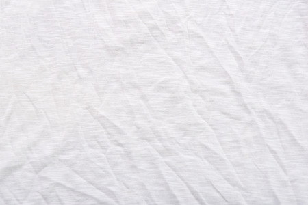 Close up of wrinkled white color fabric bed sheet texture background.