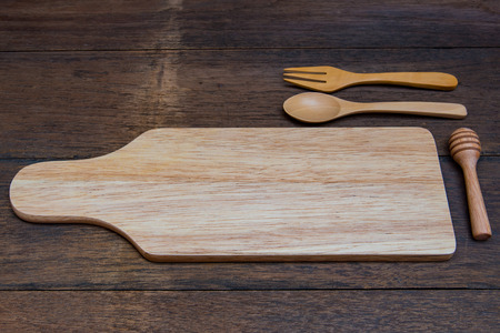 Close up of natural wooden dish with wooden spoon and fork on wood plank.の写真素材