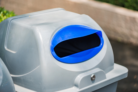 Close up of gray color plastic recycle bin stand in the garden.の写真素材