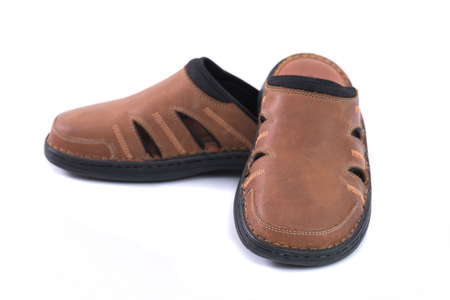 Close up of beautiful brown sandal made with real leather on white background isolated.の写真素材
