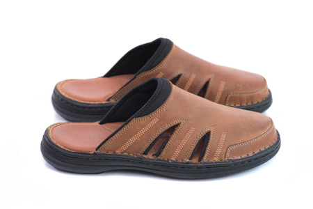 Close up of beautiful brown sandal made with real leather on white background isolated.