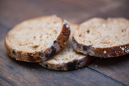 Close up of black fungus on expire organic french bread made from wheat flour raisin and multi grain...