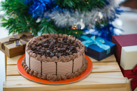 Close up of chocolate cake with fresh cream topping with chocolate chunk and dark chocolate ice...