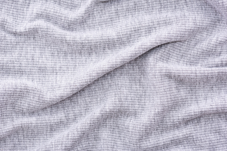 Close up of wrinkled grey cotton fabric texture background.