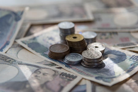 Close up of japan currency banknote and coin on the background.