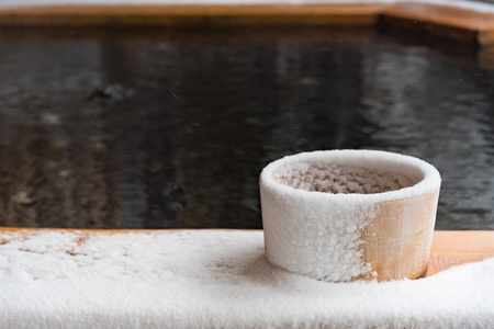 Japan natural mineral hot spring called onsen cover by snow in Japanese ryokan on the moutain okuhida takayama japan.の写真素材