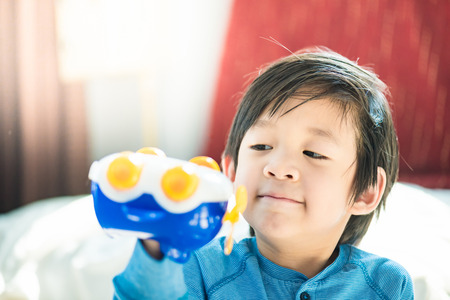 Close up of cute asian boy play and smiling in home.の写真素材