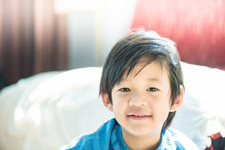 Close up of cute asian boy play and smiling in home.の写真素材