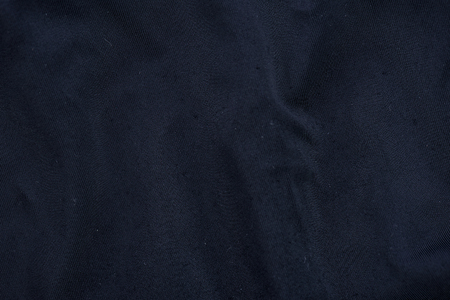 Close up of old wrinkled black fabric bedsheet textured background.の写真素材