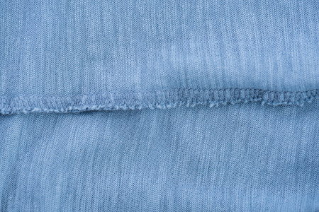 Close up of light blue wrinkled bedsheet fabric textured background.の写真素材