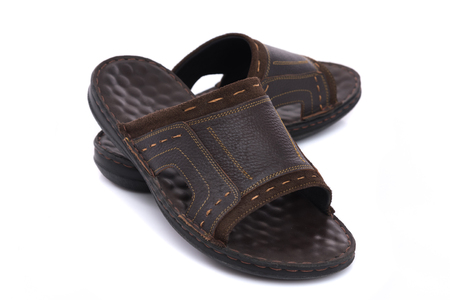 Close up of beautiful brown leather sandal on white background isolated.の写真素材