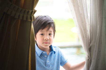 Close up of happy asian child play in the garden in morning.の写真素材