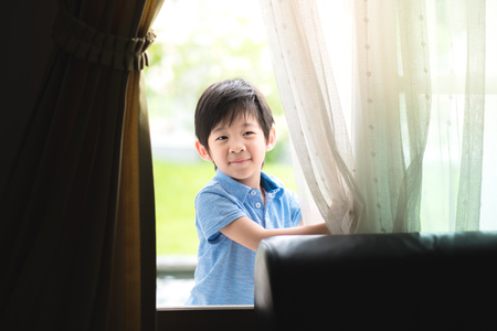 Close up of happy asian child play in the garden in morning.の写真素材