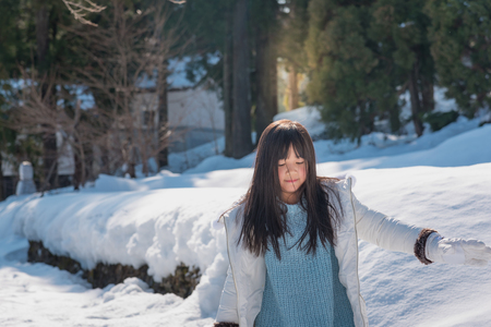Beautiful asian girl walking around snow moutain in japanese village shirakawago takayama Japan.の写真素材