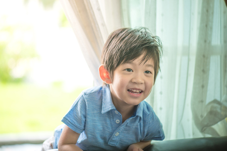 Close up of happy asian child play in the garden in morning.の写真素材